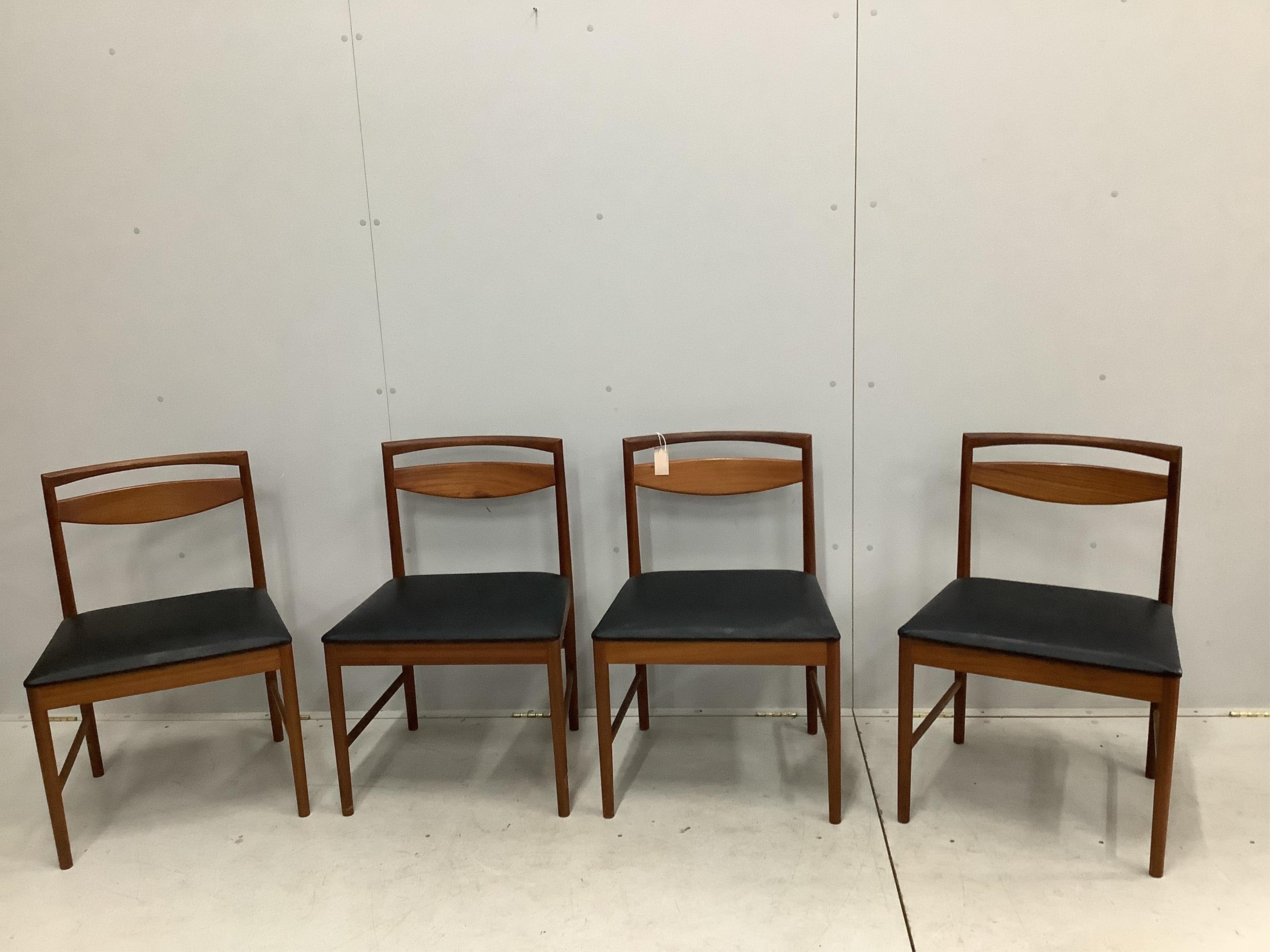 A mid century McIntosh teak extending dining table, width 150cm, depth 82cm, height 74cm together with four chairs, and a low sideboard. Condition - fair to good